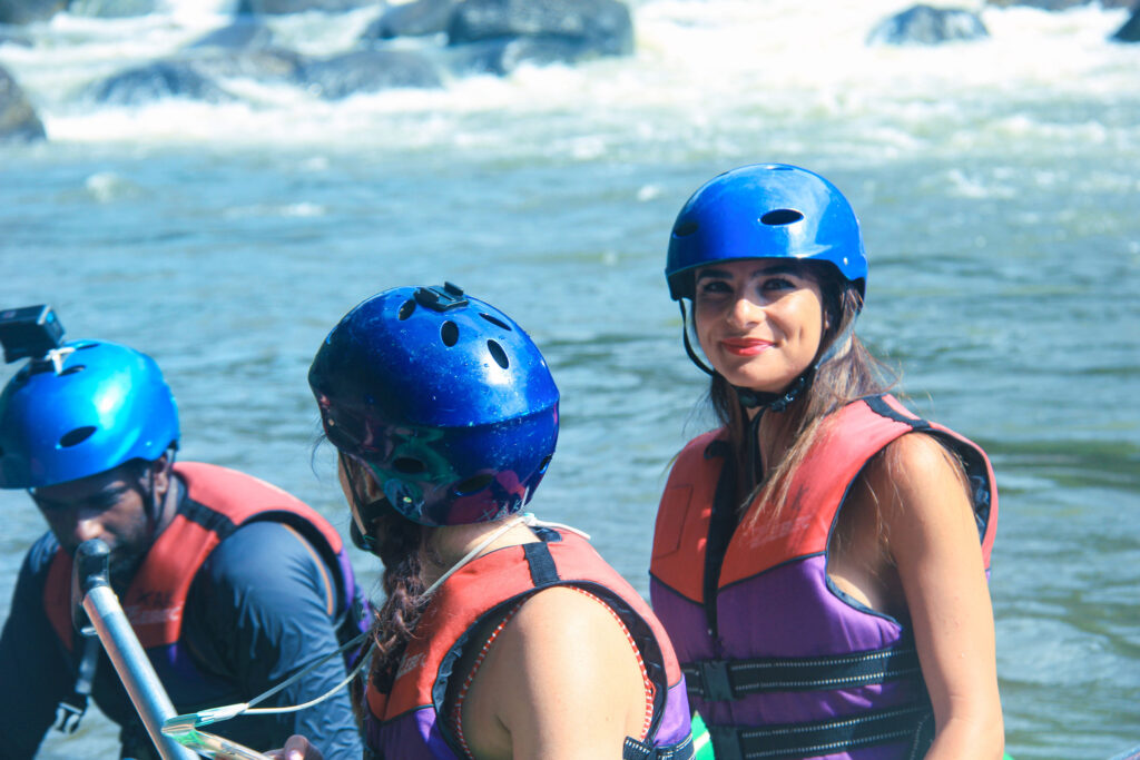 Smiling Lady in a swim suit water rafting at Kithulgala Sri Lanka